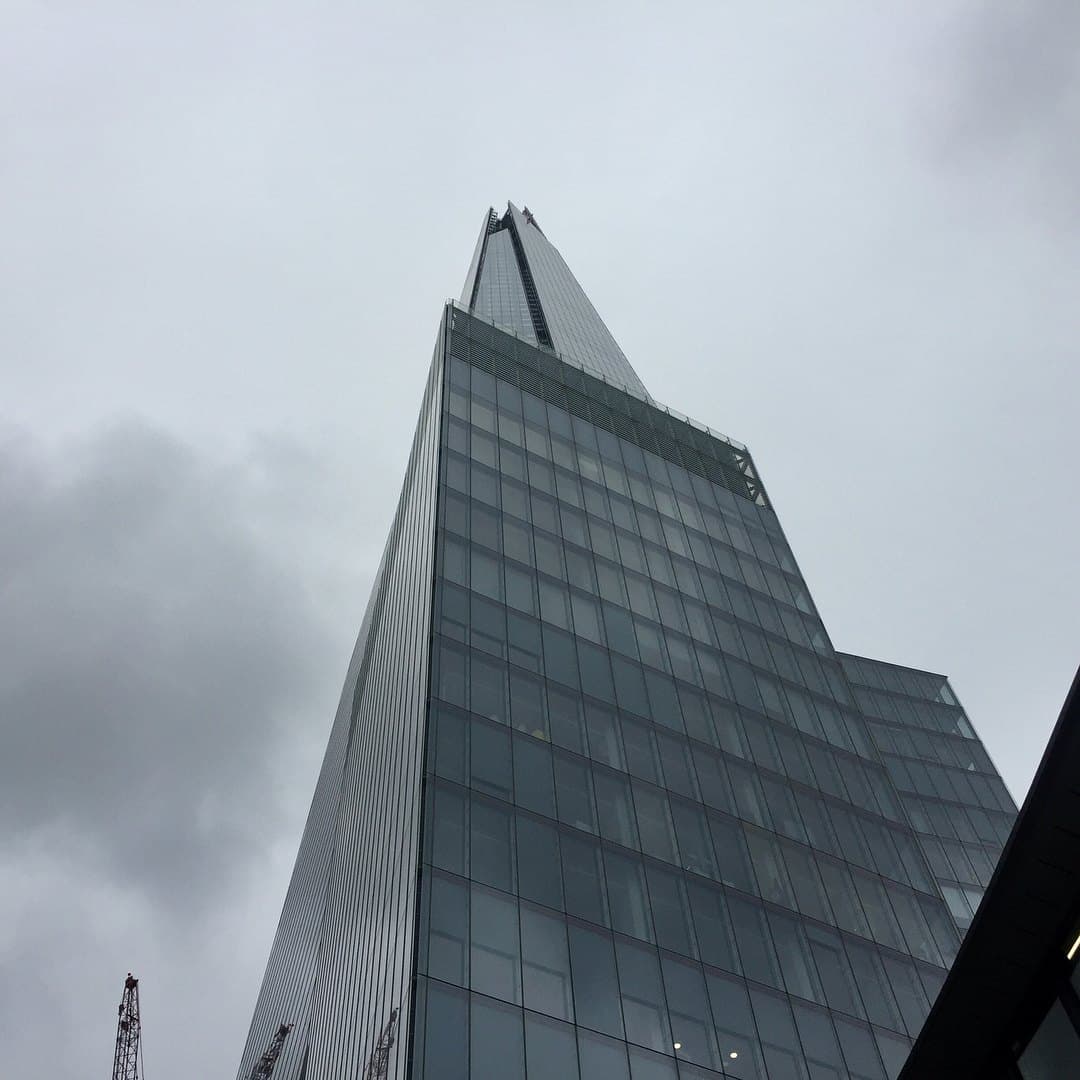 The Shard’s glass facade rising into grey cloud